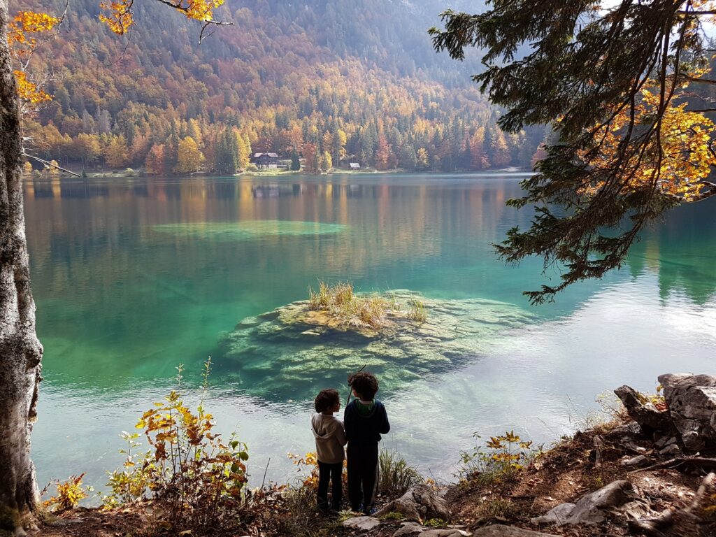 Children playing by Lake Fusine in Italy