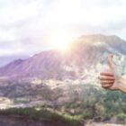 Thumbs up, mountain background